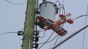 Model plane stuck in power line