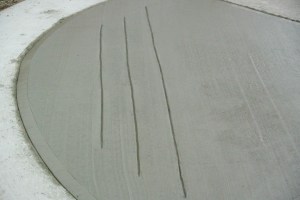 A curb to sidewalk concrete entrance is poured, with feeling slots for the blind. Photo KDG